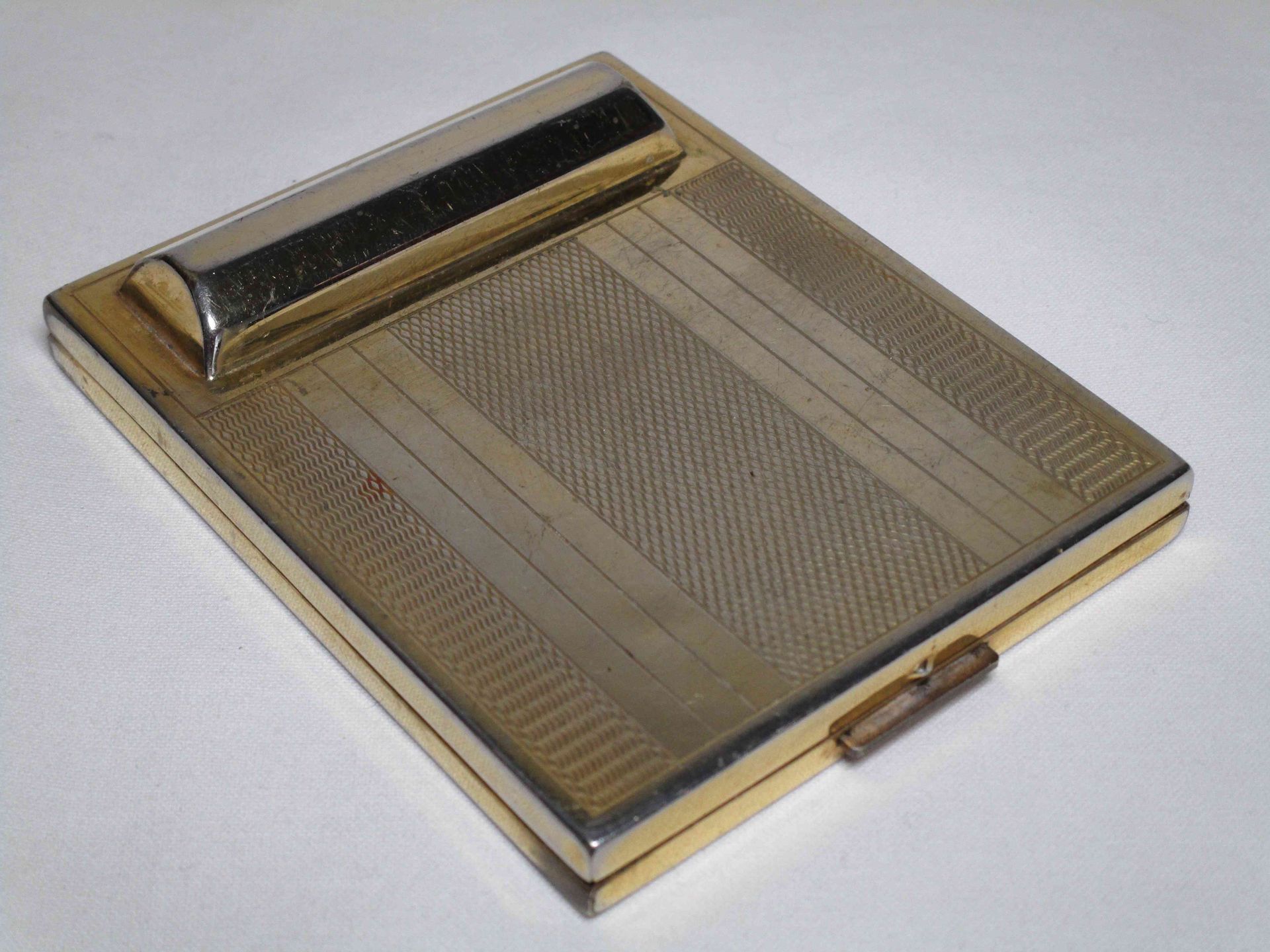 A gold tone metal rectangular powder compact with a lipstick holder, from France