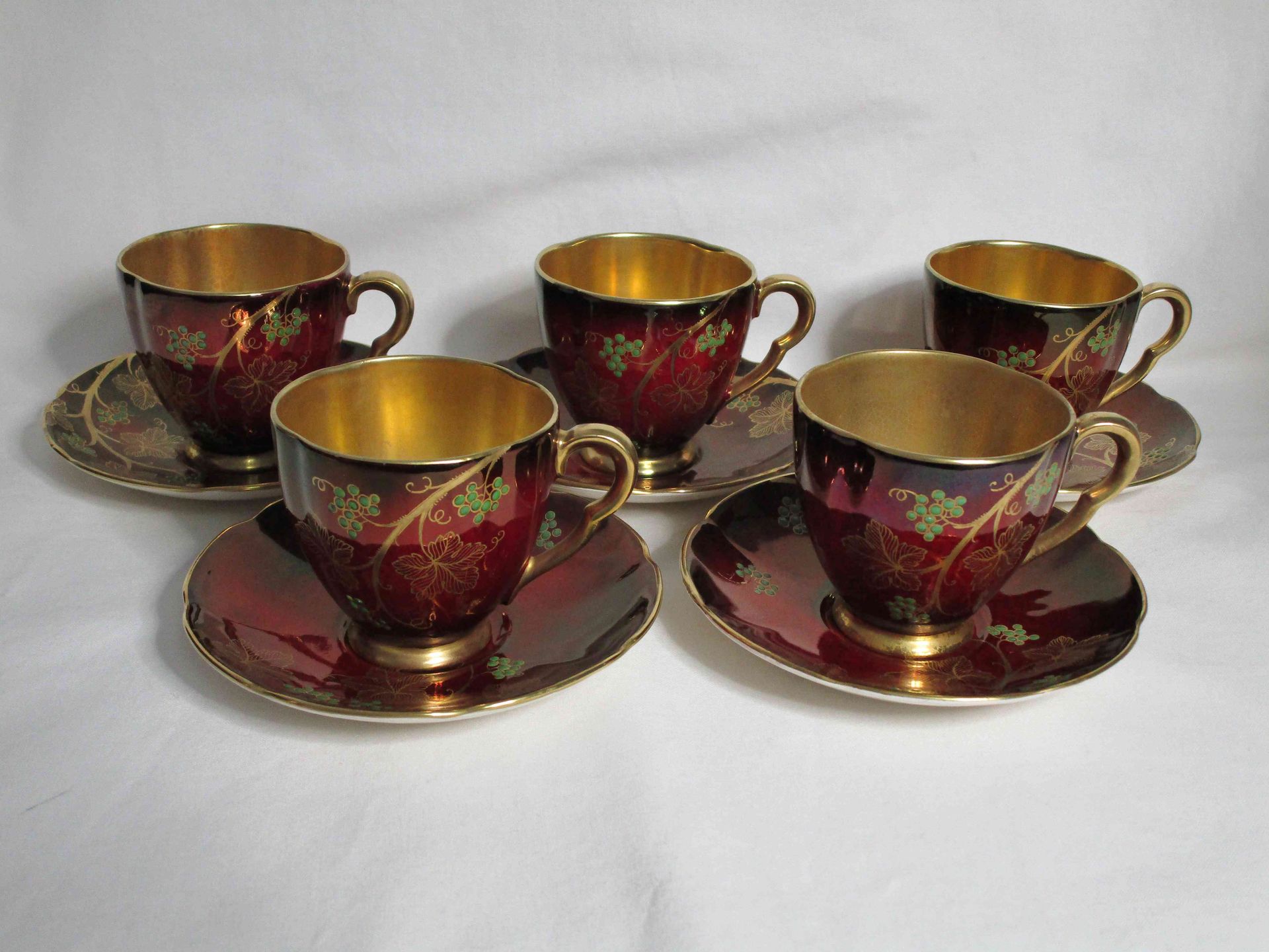 A set of five Carlton Ware 'Rouge Royale' 1940's demitasse coffee duos with 'Fruiting Vine' and gold detail