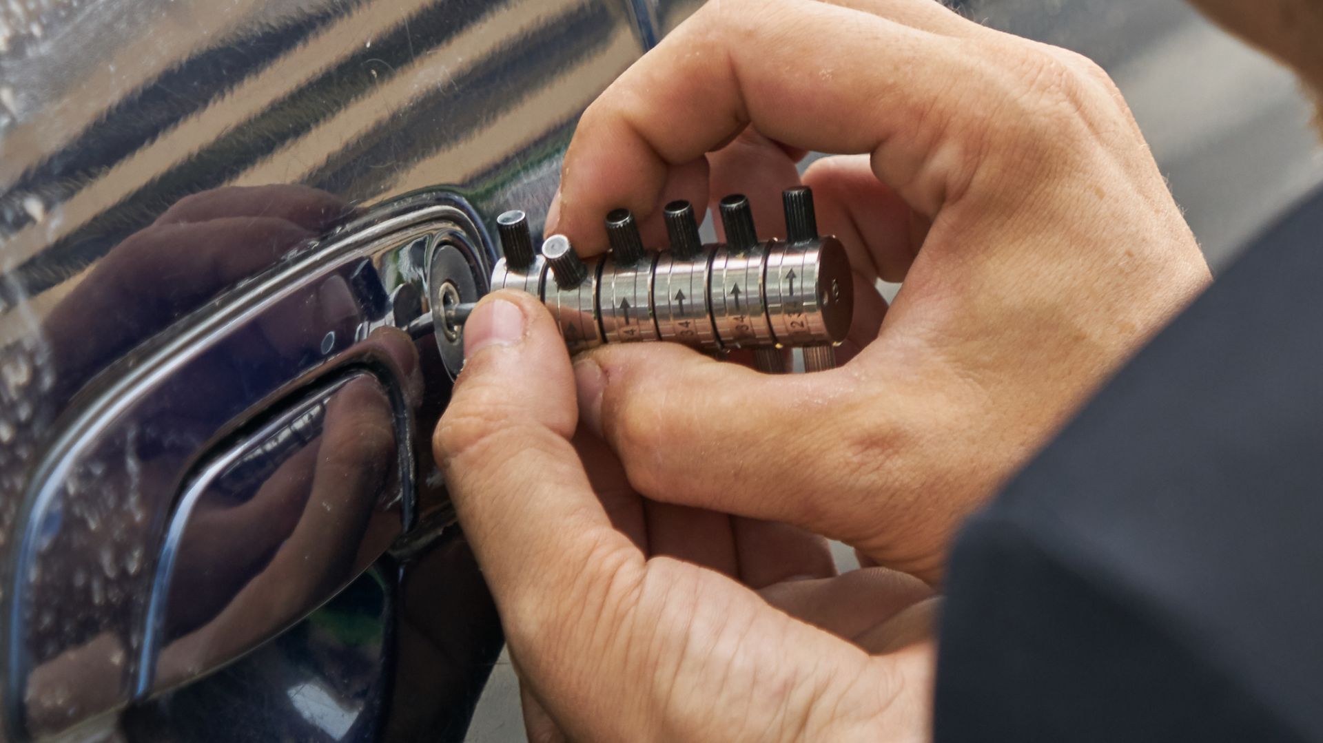 Hands adjusting the combination lock on a purple bag or suitcase
