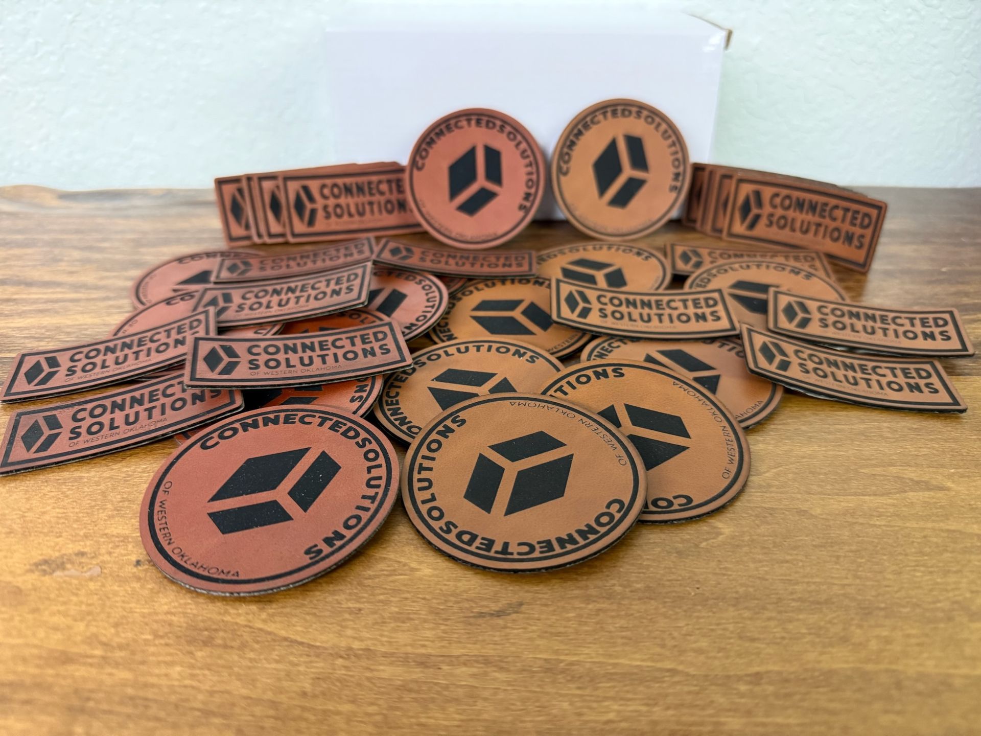 A pile of circular and rectangular leather patches with the 