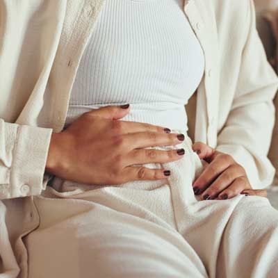 A woman feeling bloated from Diverticulitis