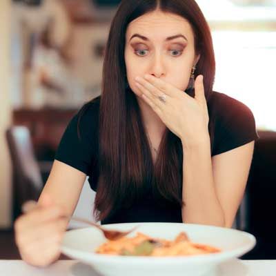 A woman with gallbladder issues is feeling nauseated while eating