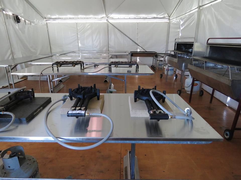 A stainless steel table with two burners on it