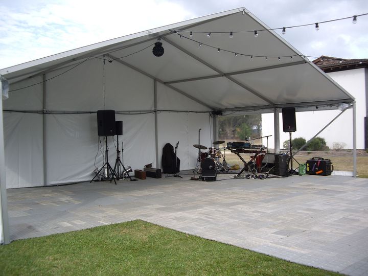 A large white tent with a stage set up underneath it