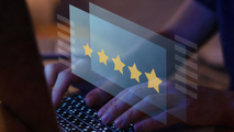 Hands typing on a laptop with a translucent 5-star rating overlay.