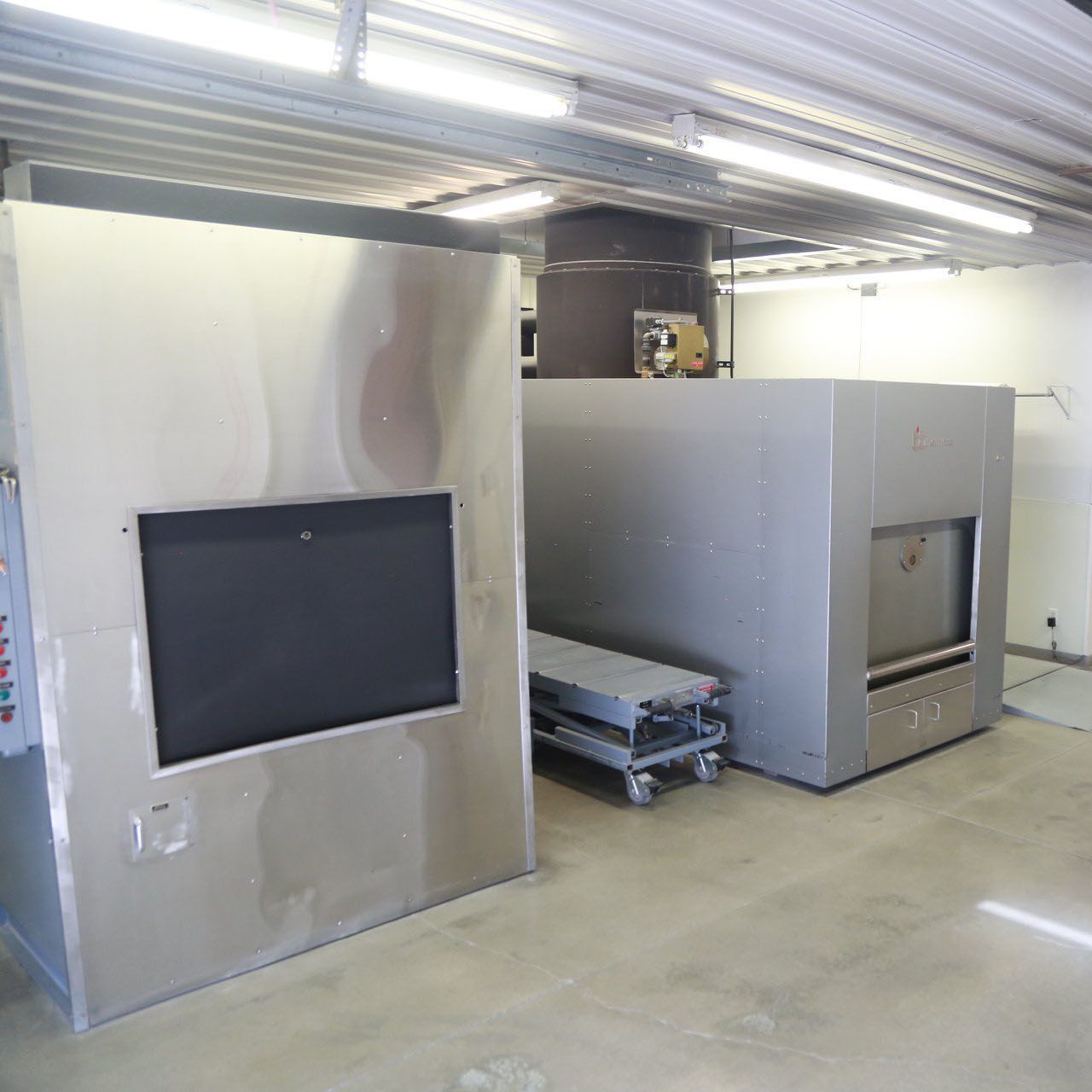 A room with two stainless steel boxes on the wall