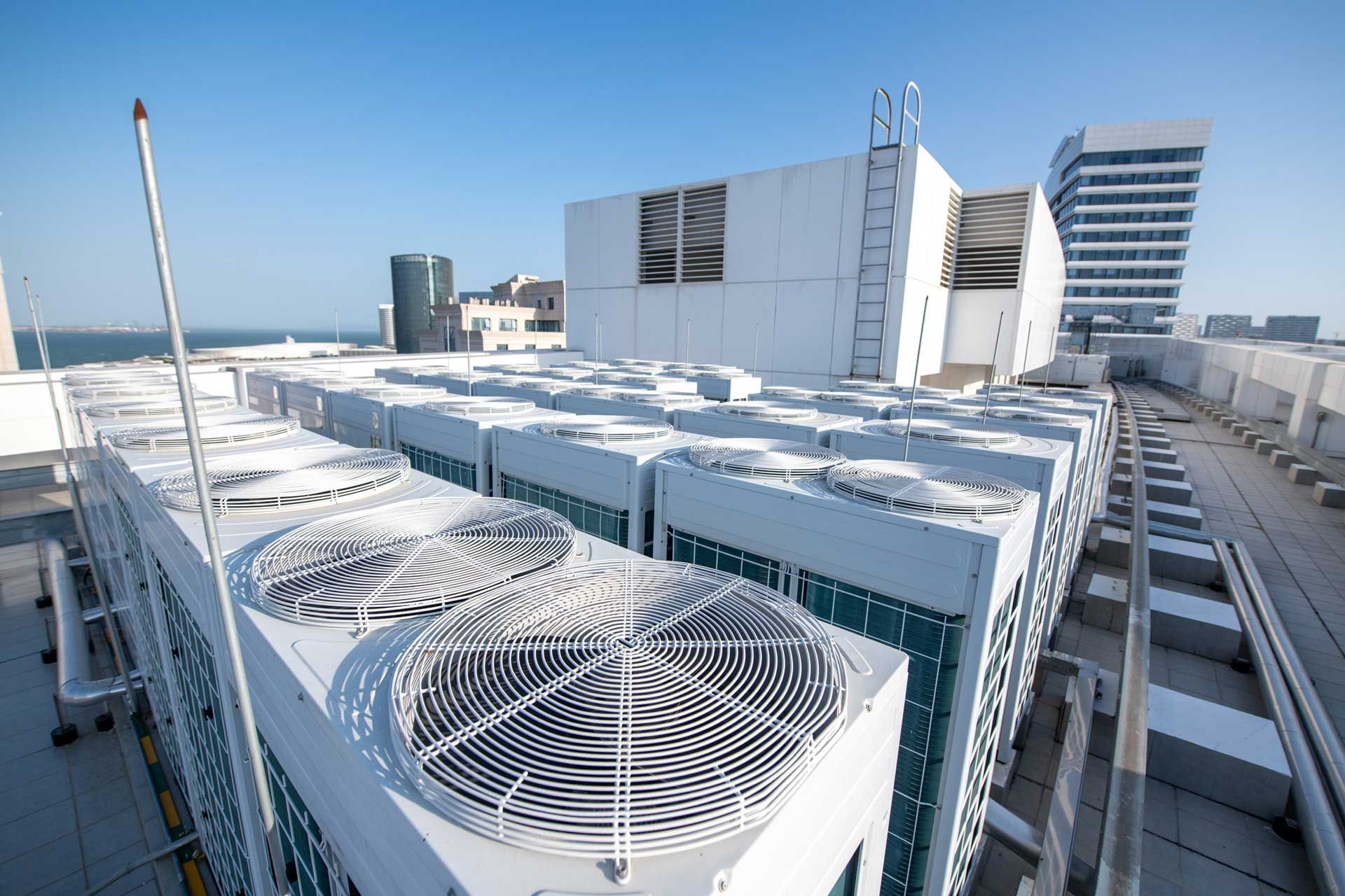 A rooftop with a lot of air conditioners on it