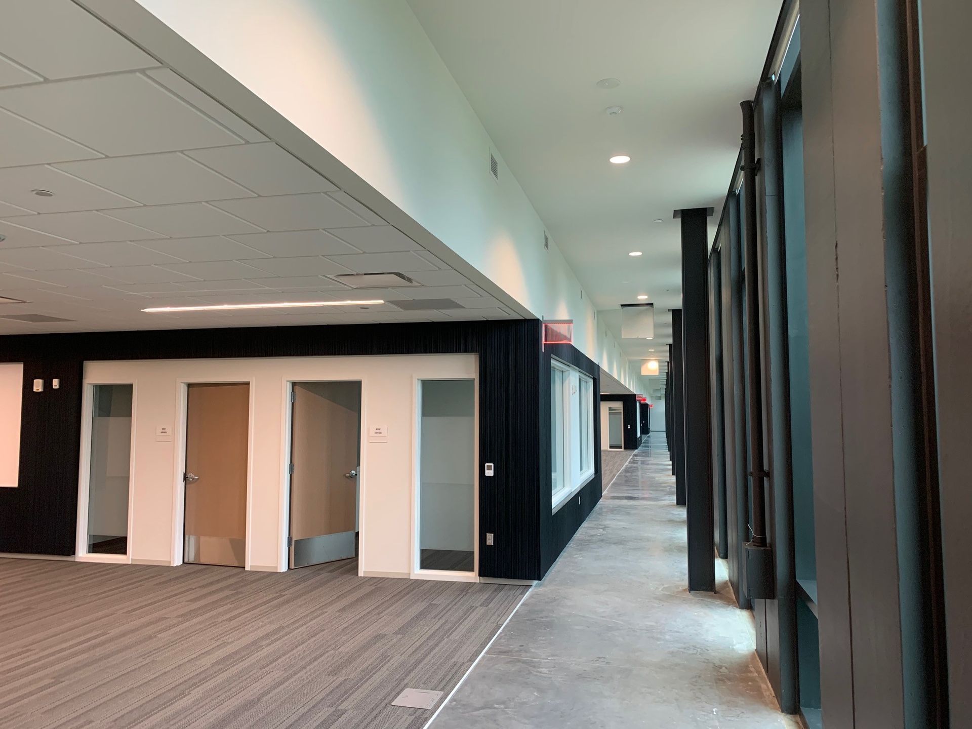A long hallway with a lot of windows and doors