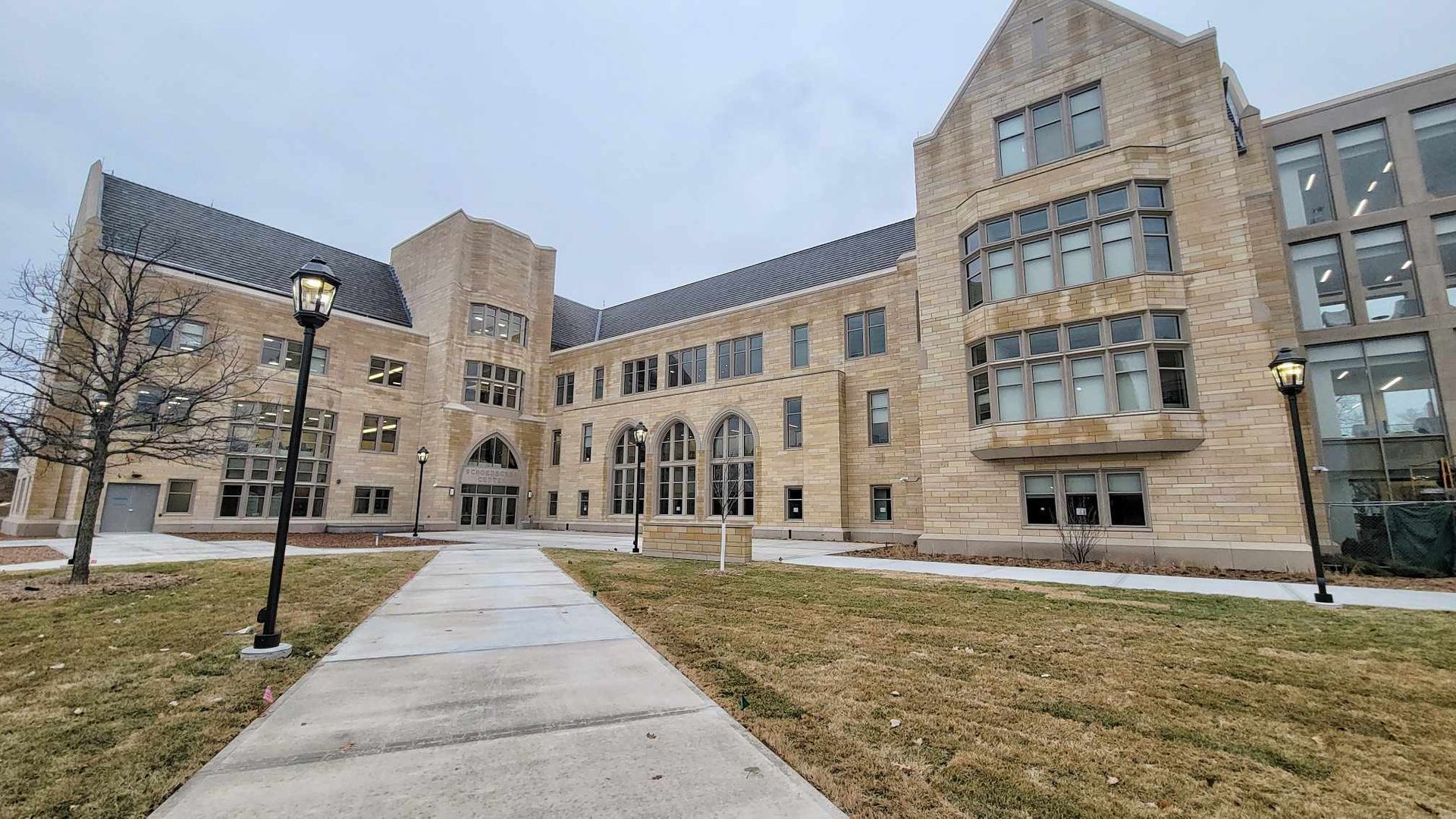 A large brick building with a walkway leading to it.