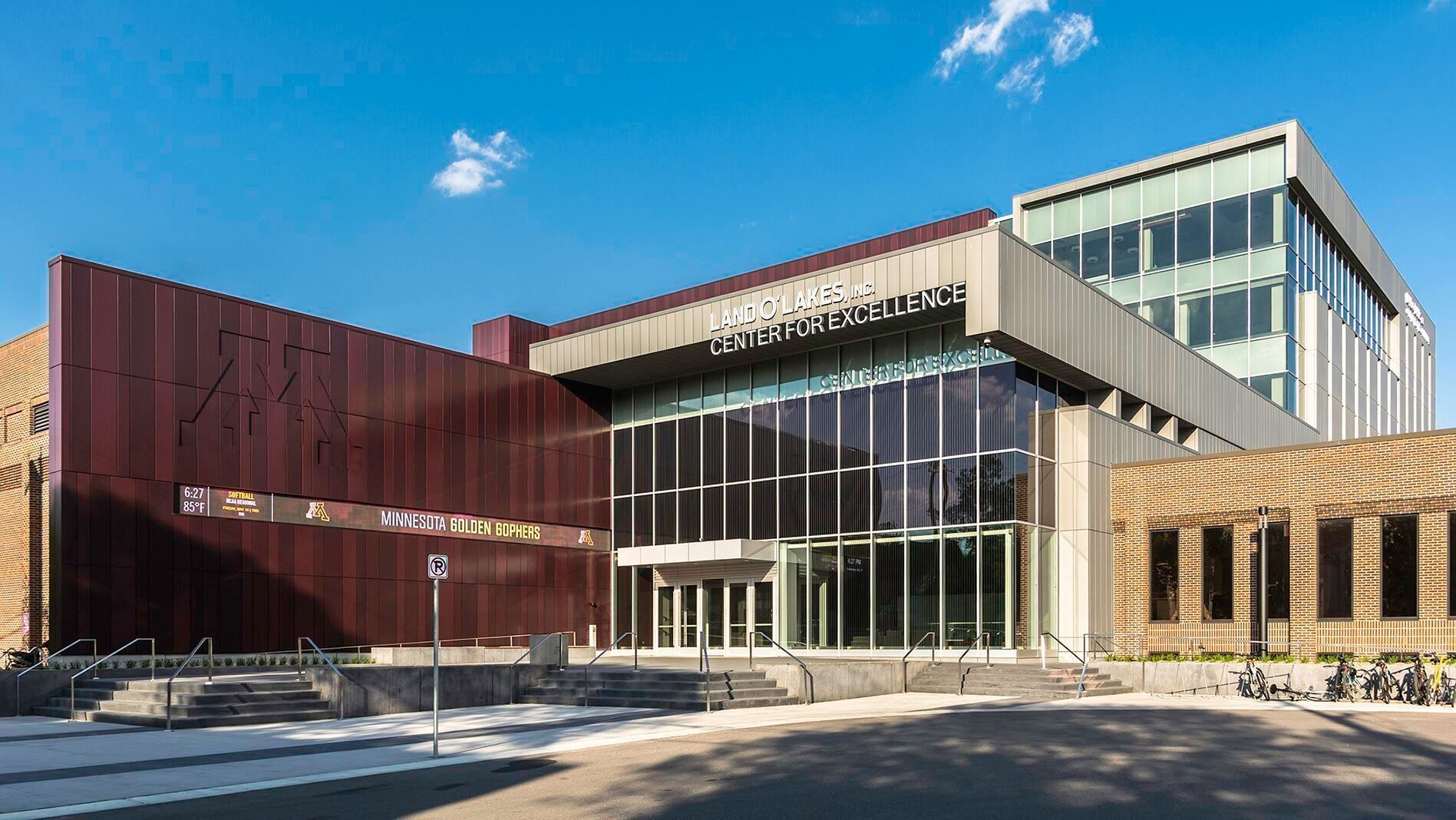 A large building with a lot of windows and a blue sky in the background.
