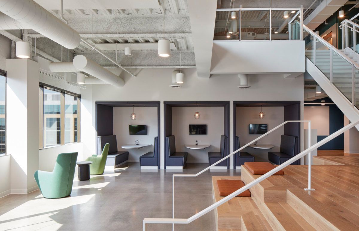 A large room with stairs leading up to the second floor
