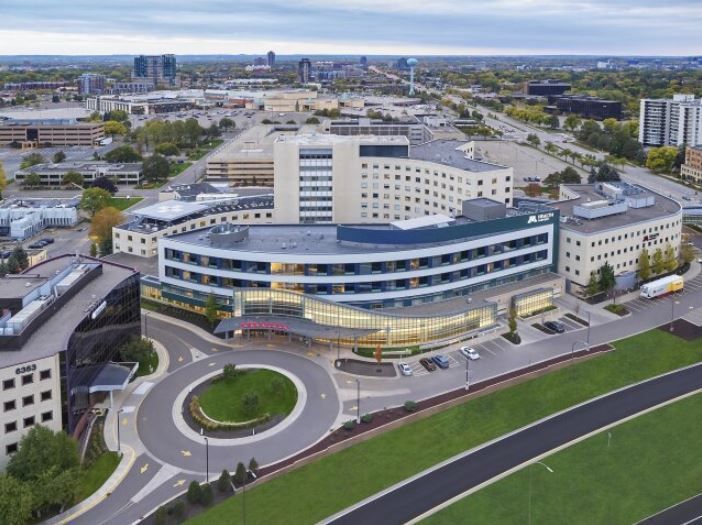 An aerial view of a large building with a roundabout in front of it.