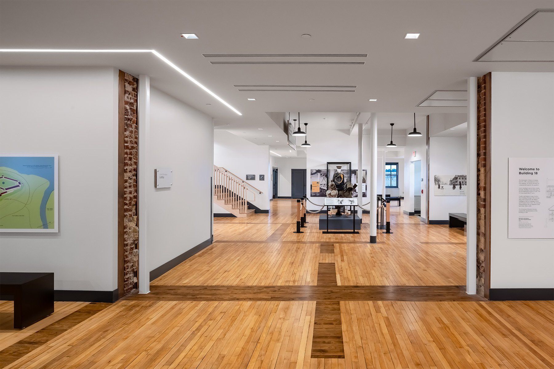 A large room with a wooden floor and white walls.