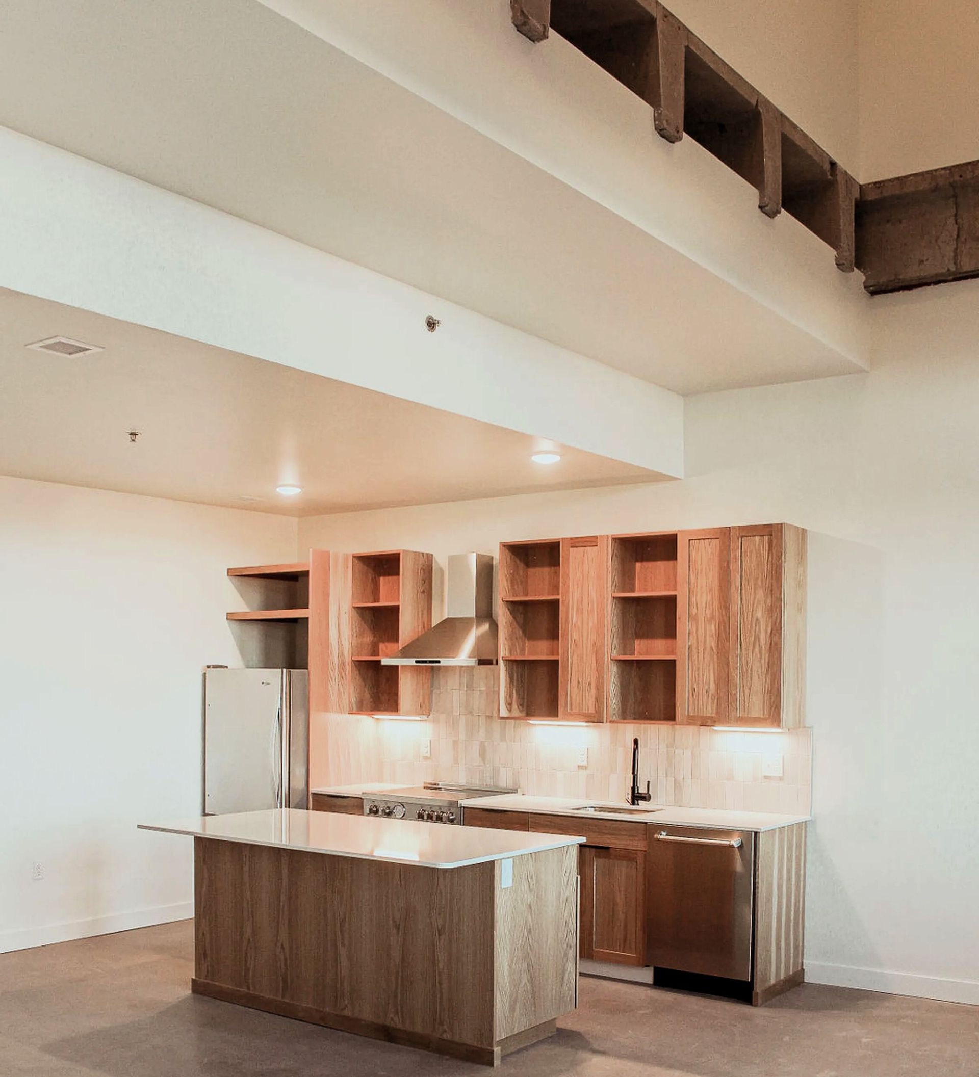 A kitchen with stainless steel appliances and wooden cabinets