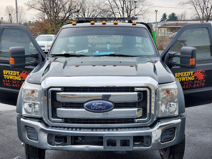A ford truck is parked in a parking lot with its doors open.