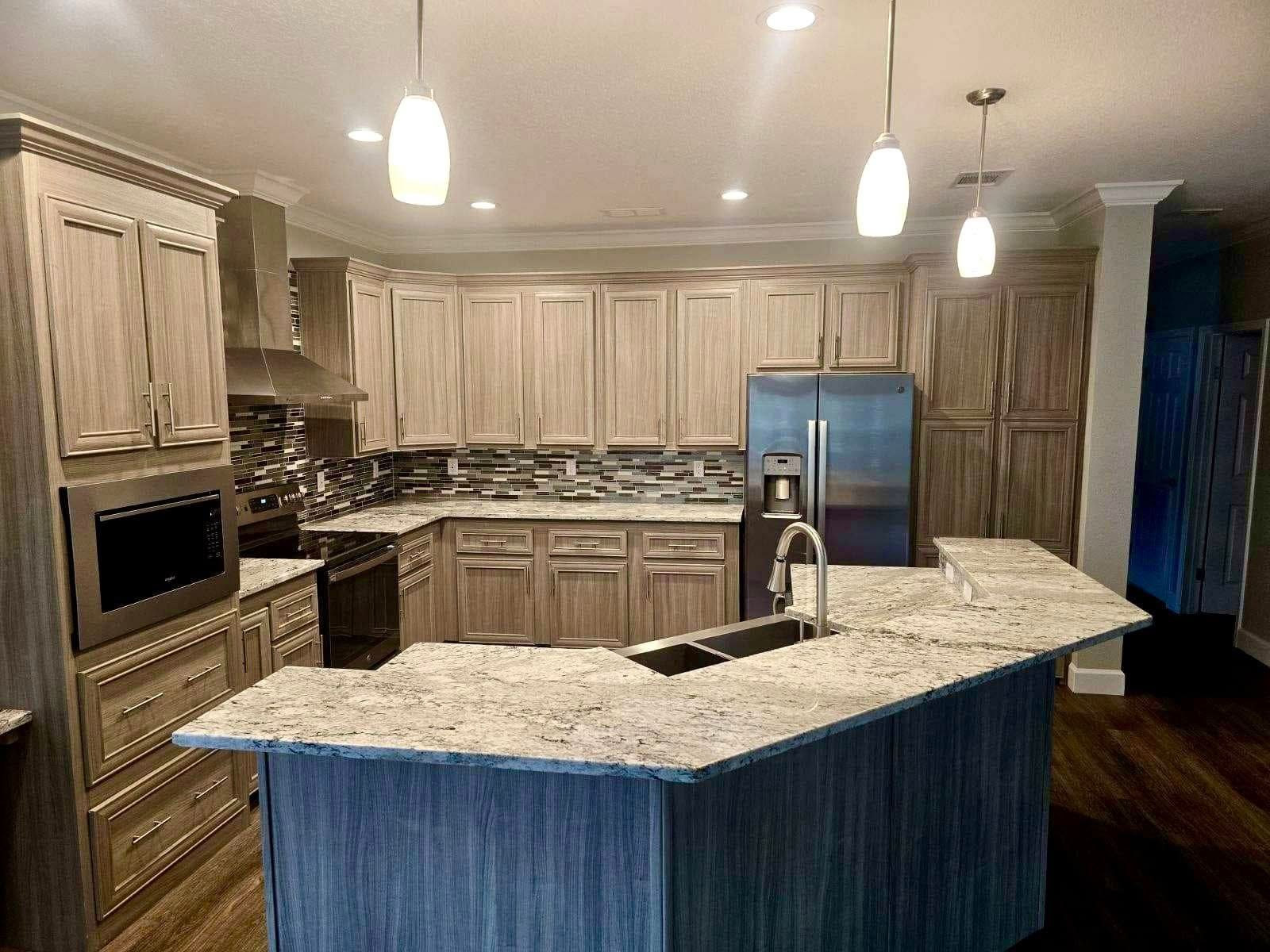 Spacious kitchen with wood cabinets, granite countertops, and stainless steel appliances.