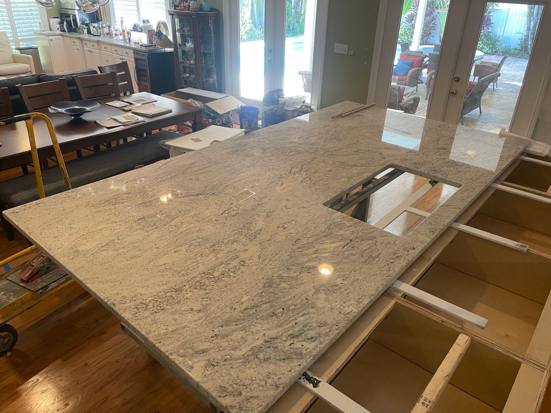 Granite countertop installed over kitchen cabinets, with a sink cut-out. Interior shot of a kitchen.