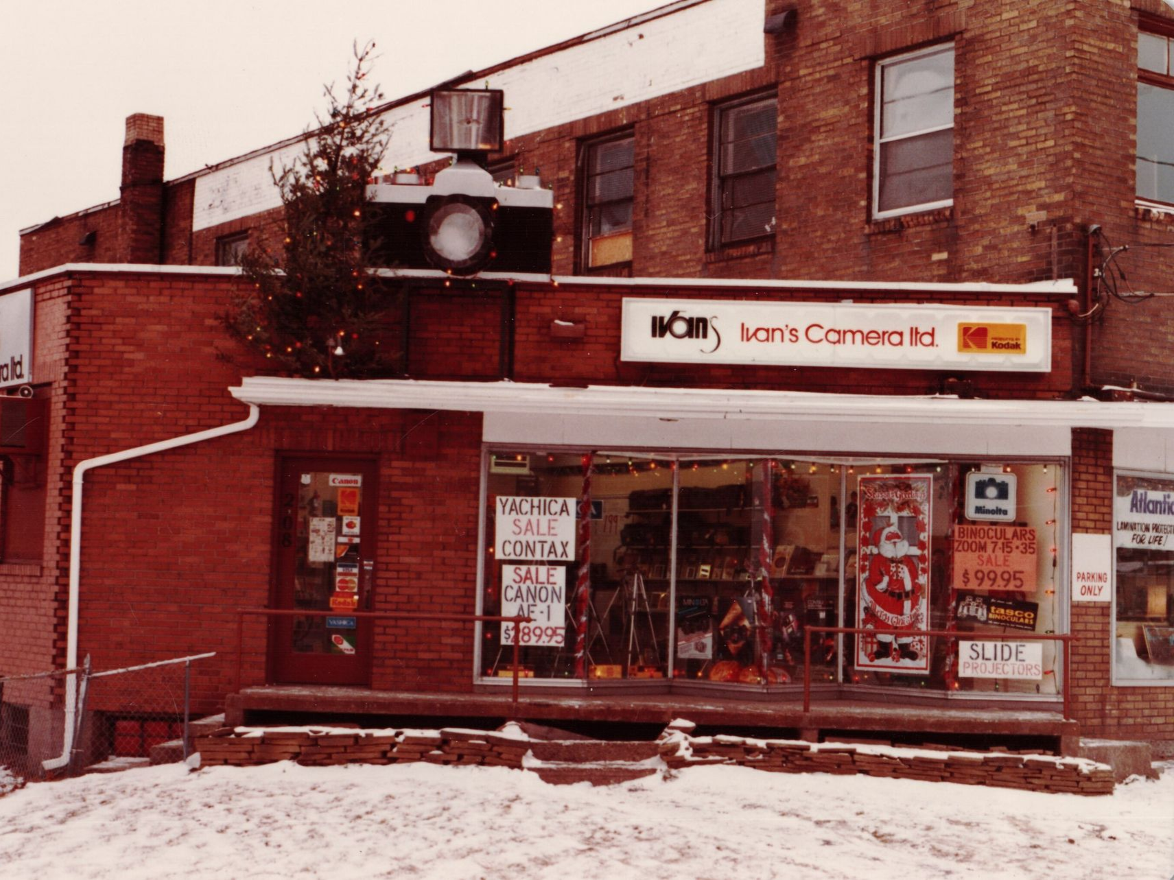 Snowy brick storefront with camera shop signage and display windows