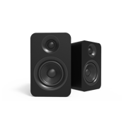 Two black speakers on a white background, one facing forward and one angled behind it.