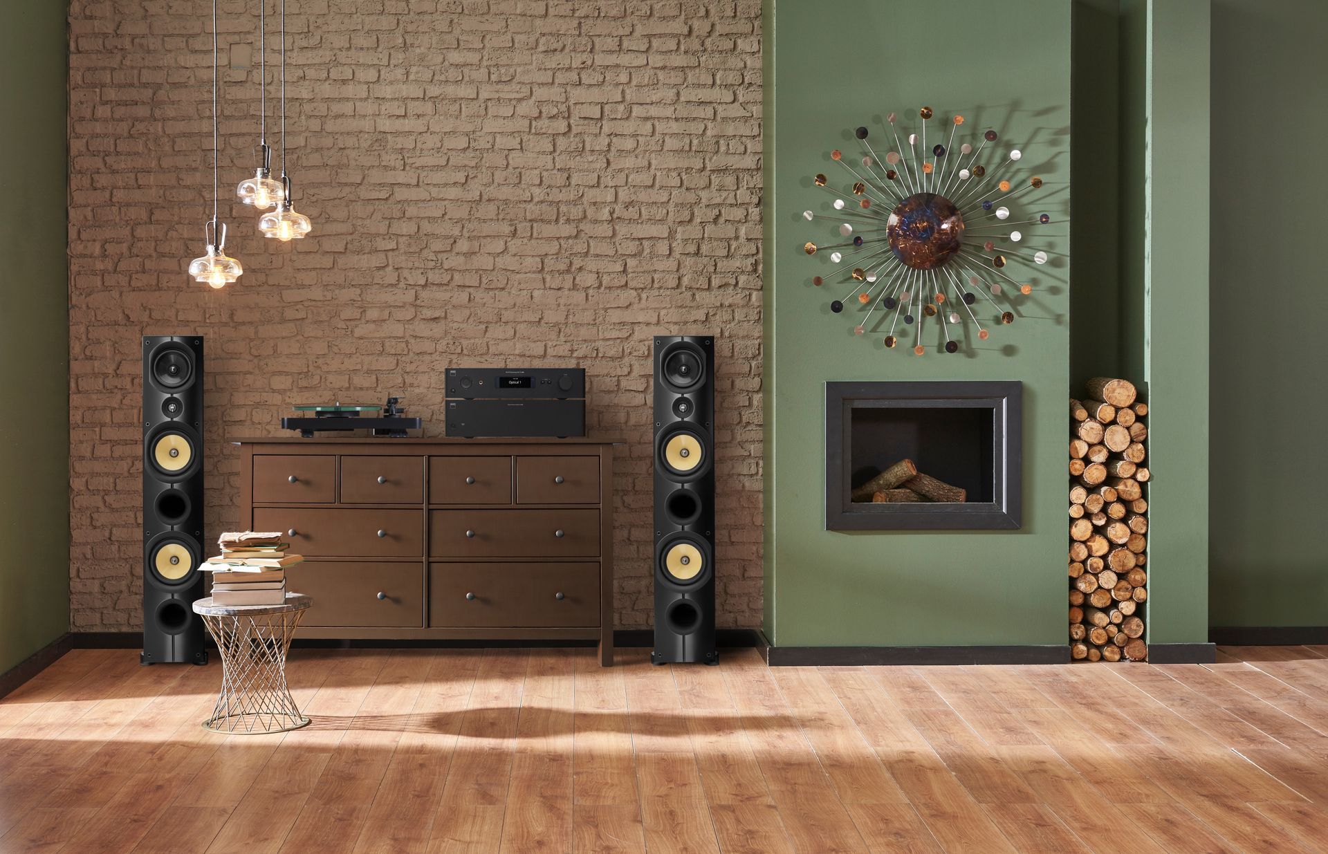 Modern living room with wood floor, brick accent wall, cabinets, speakers, and a green fireplace wall