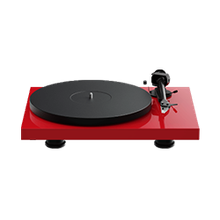 Red turntable record player with black platter and tonearm on a white background