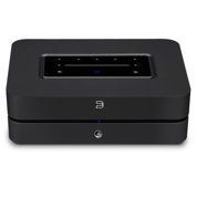 Black electronic device with a recessed control panel on top and a circular power button on the front