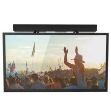 Crowd at a festival with flags at sunset, seen through a wall-mounted TV screen
