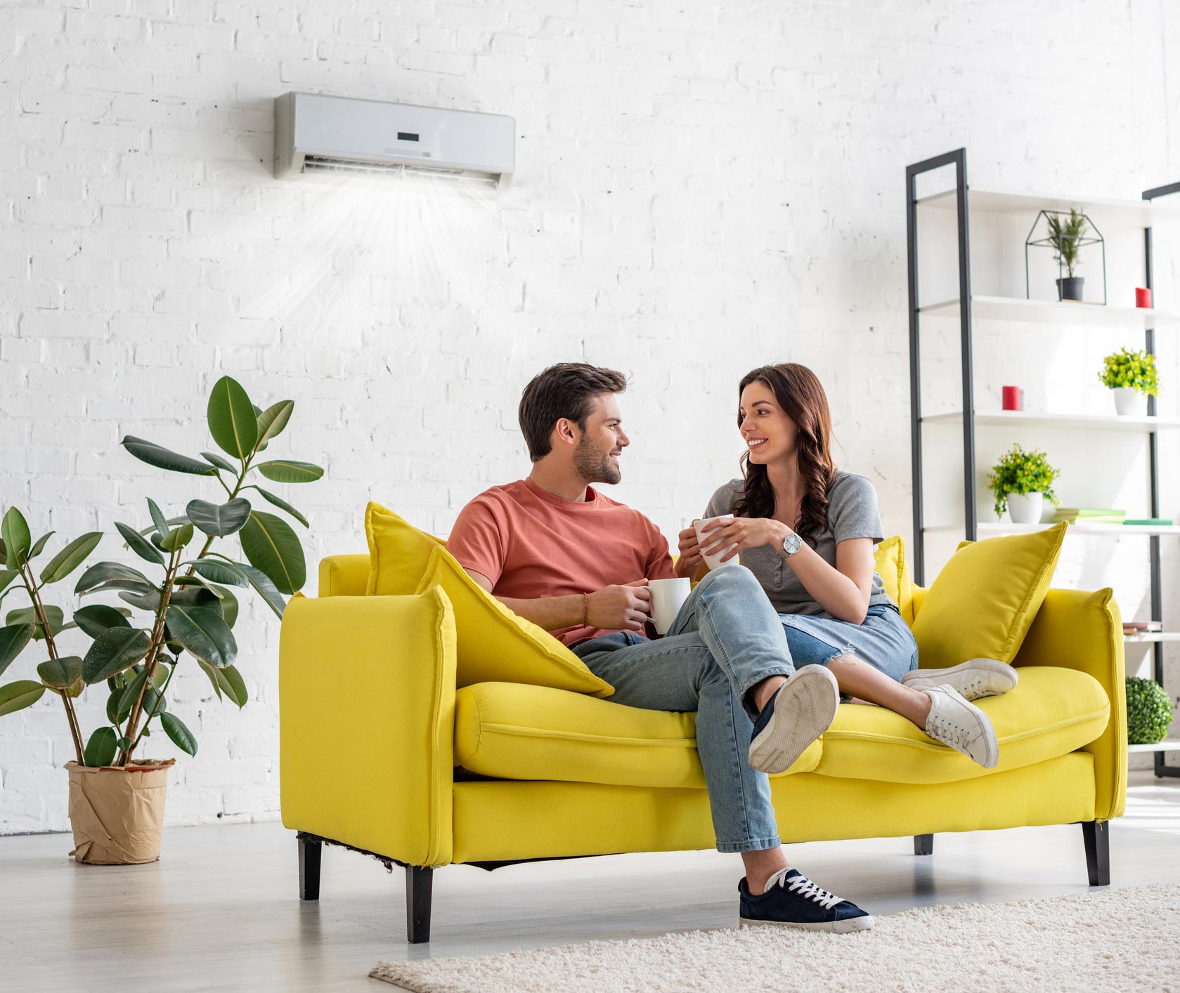Young Couple Under Air Conditioner — Pompano Beach, FL — Top Notch AC Services Young Couple Under Air Conditioner — Pompano Beach, FL — Top Notch AC Services