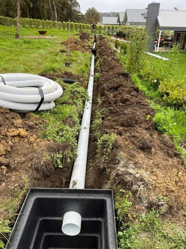 A Drain Pipe Is Being Installed In A Yard — About Time Plumbing & Civil Construction in Moss Vale, NSW
