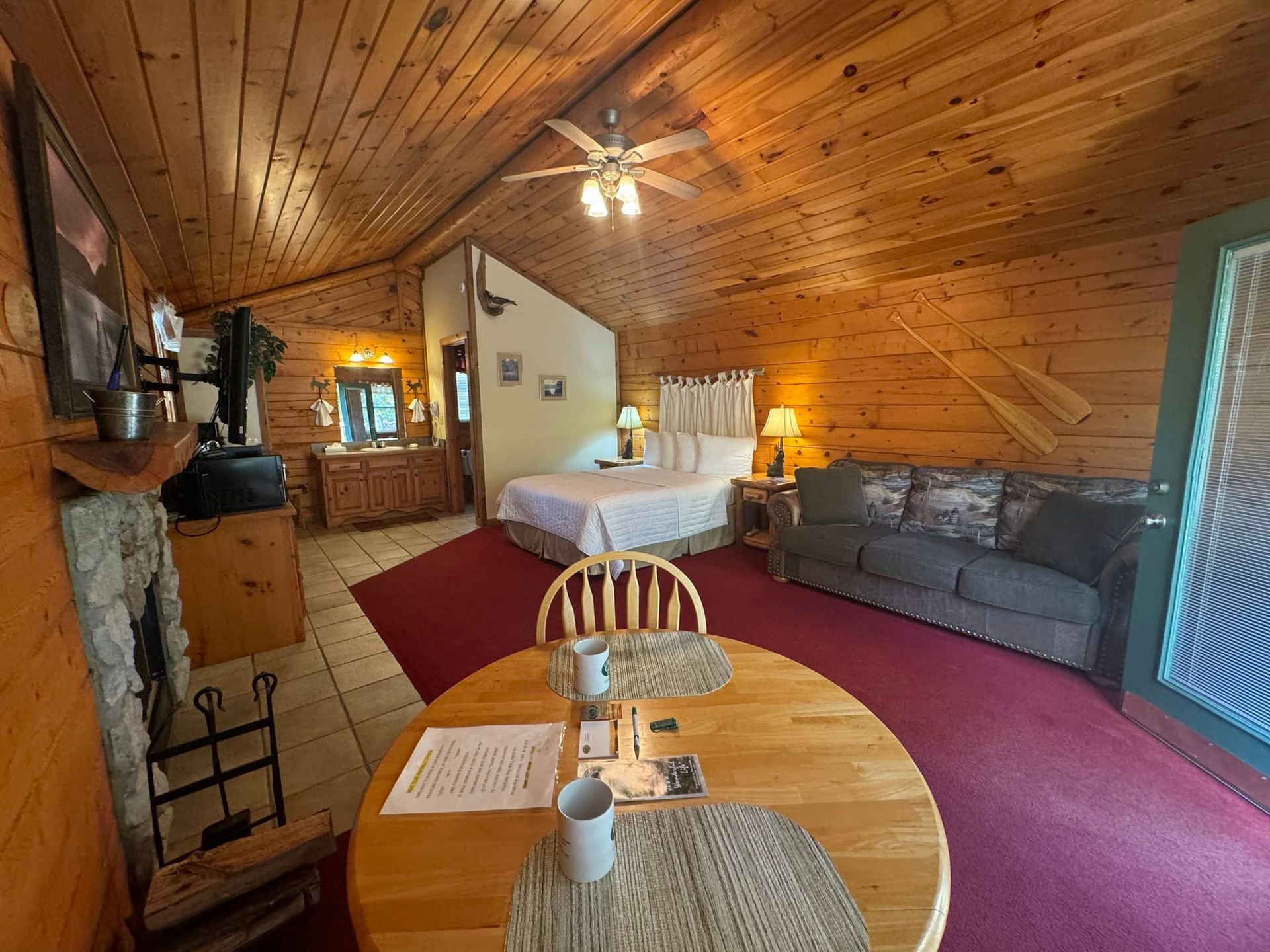 There is a table and chairs in the middle of the room.