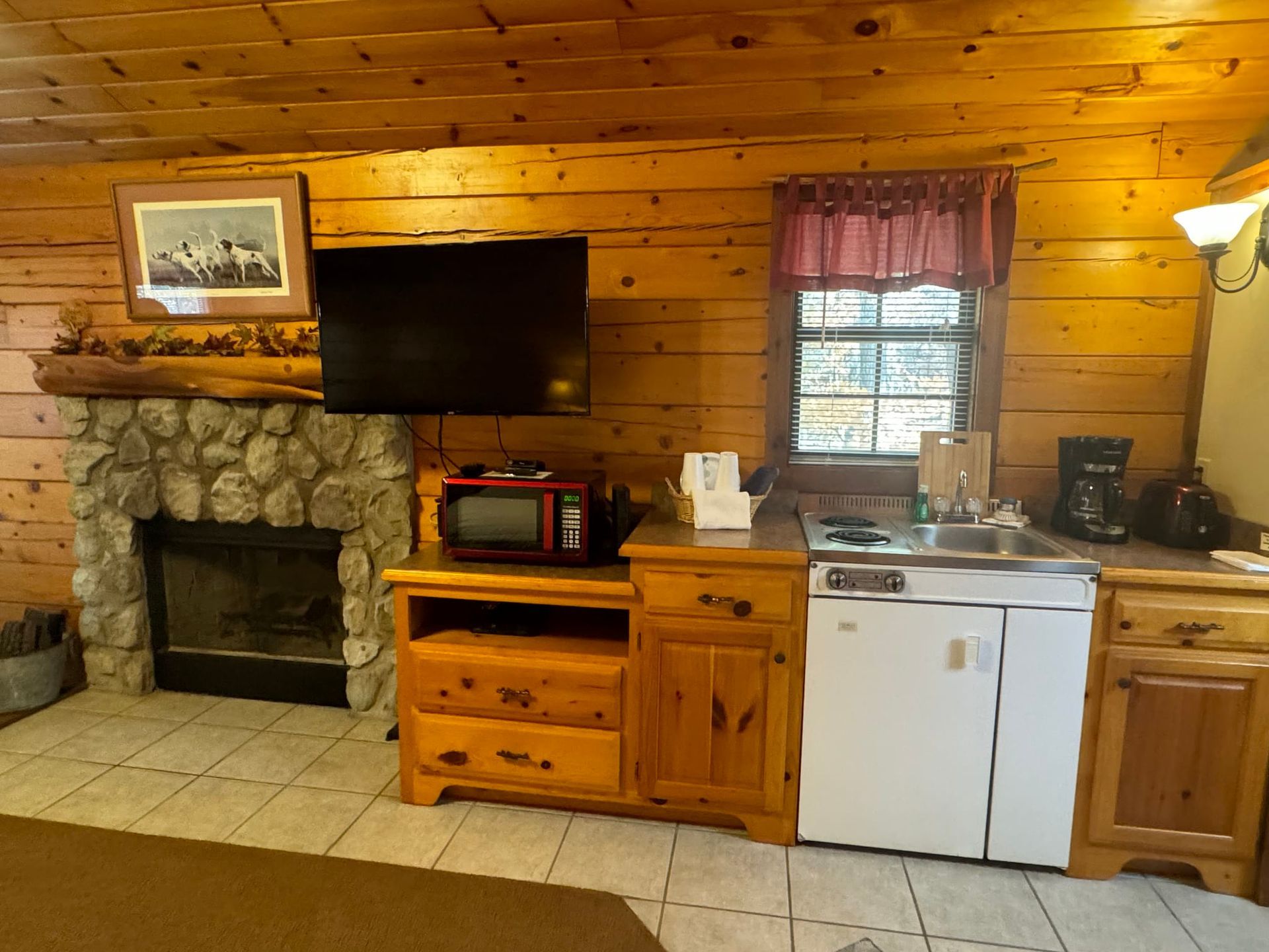 A living room with a fireplace and a flat screen tv