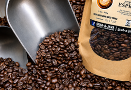 Coffee beans spilling from a scoop beside a bag of whole coffee beans