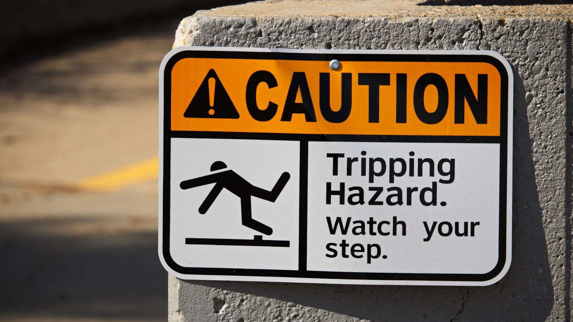 A caution sign that says tripping hazard watch your step