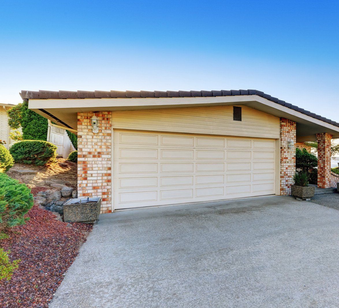 a concrete driveway leading to a house with grass on the side