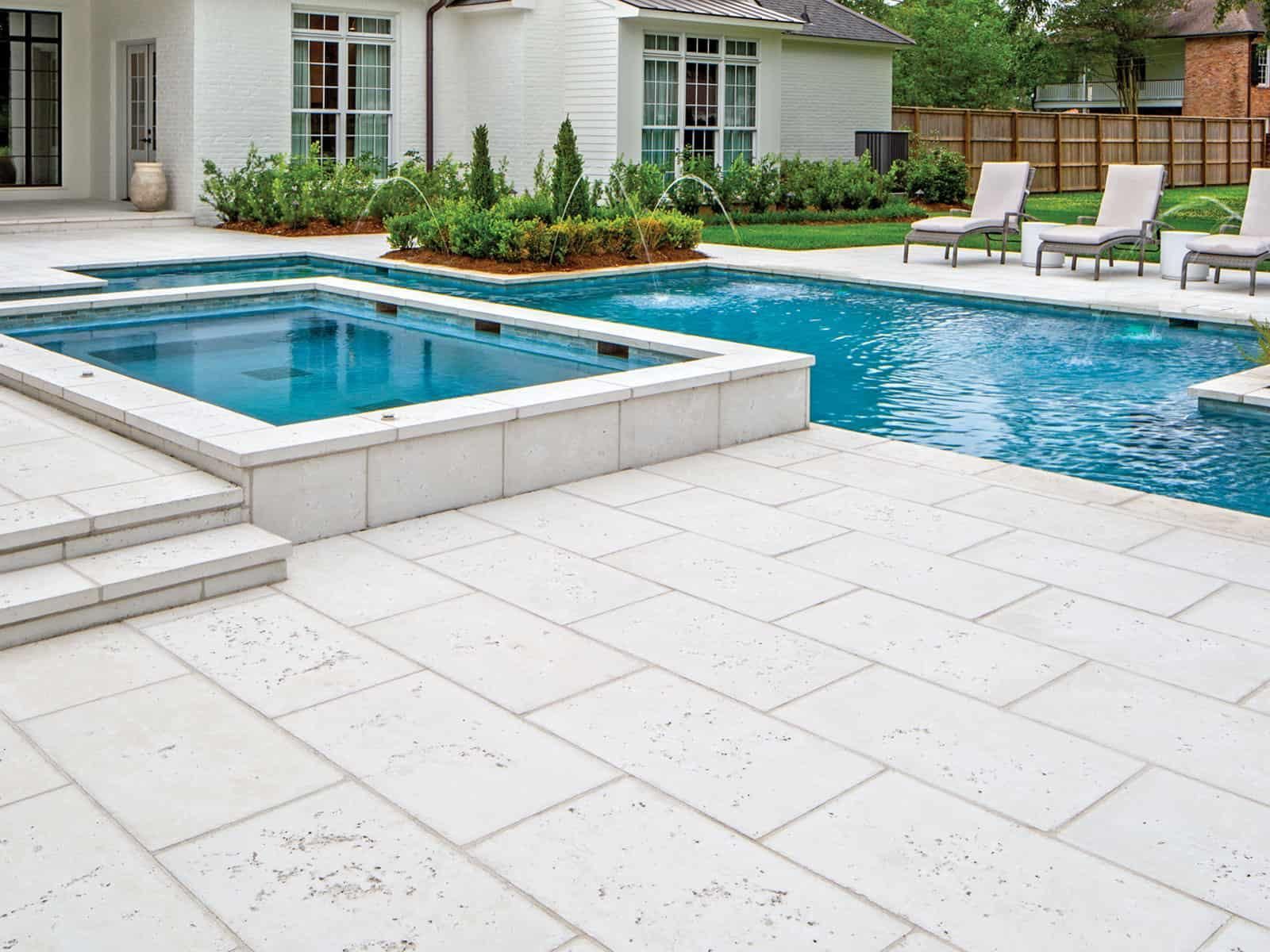 A large swimming pool with a hot tub in the middle