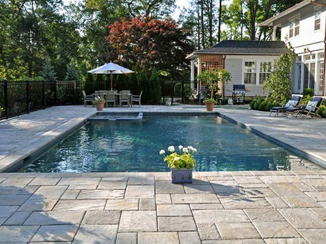 A large swimming pool in the backyard of a house