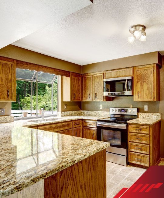 A kitchen with wooden cabinets and granite counter tops