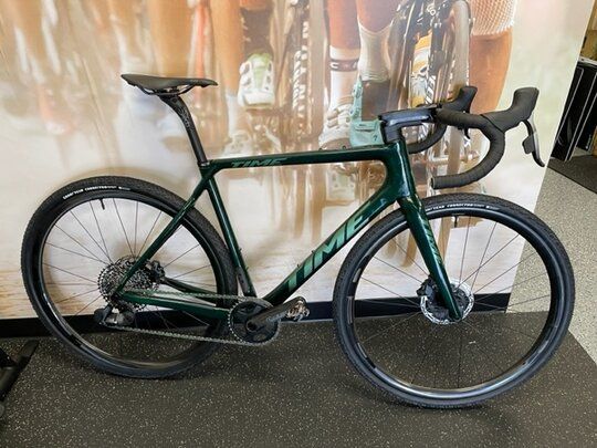 Green Time road bike with black wheels and components.