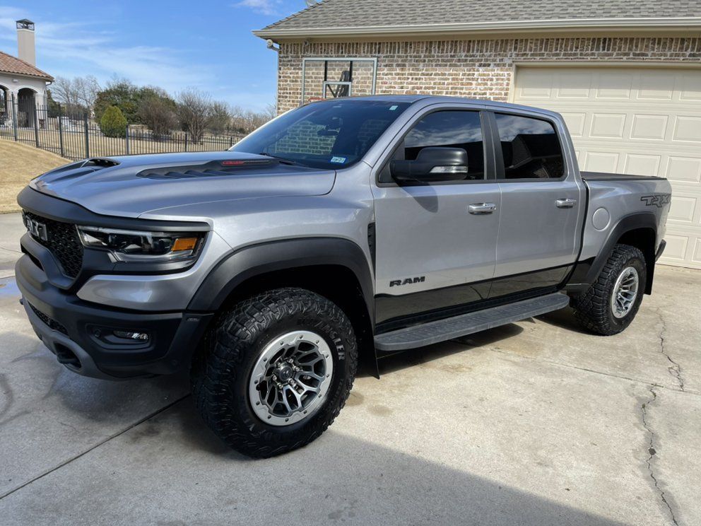 Gray Ram TRX pickup truck parked on a concrete driveway.