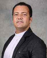 Silhouette of a person wearing a clerical collar on a plain light background