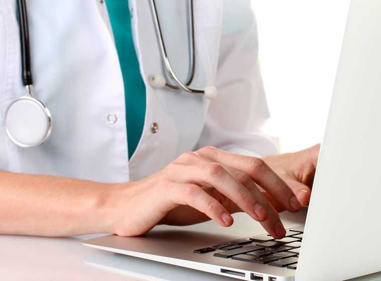 Physician reviewing and dictating edits to AI-generated clinical notes in EHR workflow