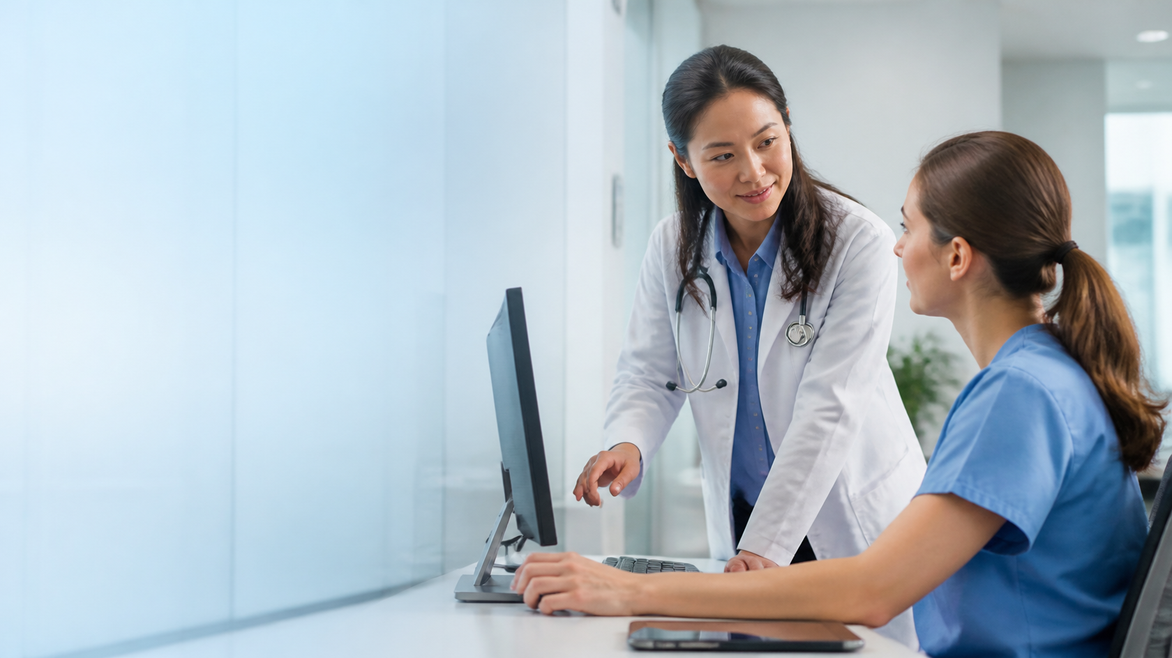 Physician discussing a virtual medical scribe workflow with a documentation specialist.