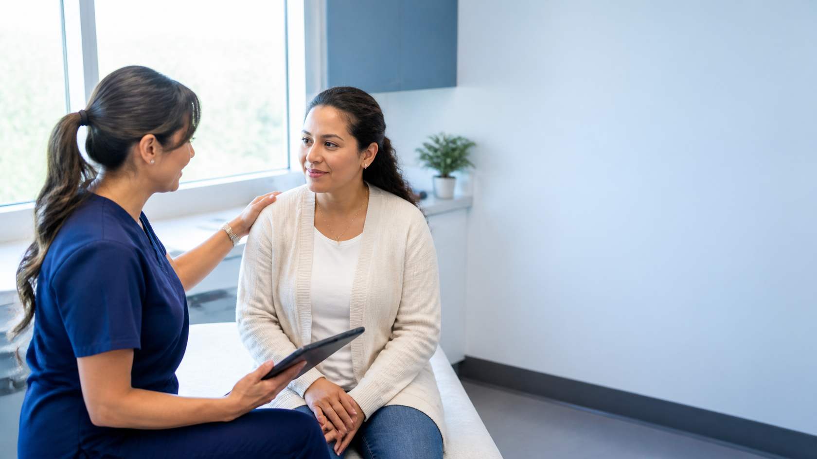 Healthcare professional speaking with a Spanish-speaking patient in a welcoming clinic.