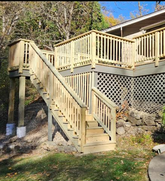 A wooden deck with stairs leading up to it