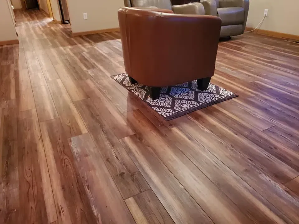 A chair is sitting on a rug on a wooden floor in a living room.