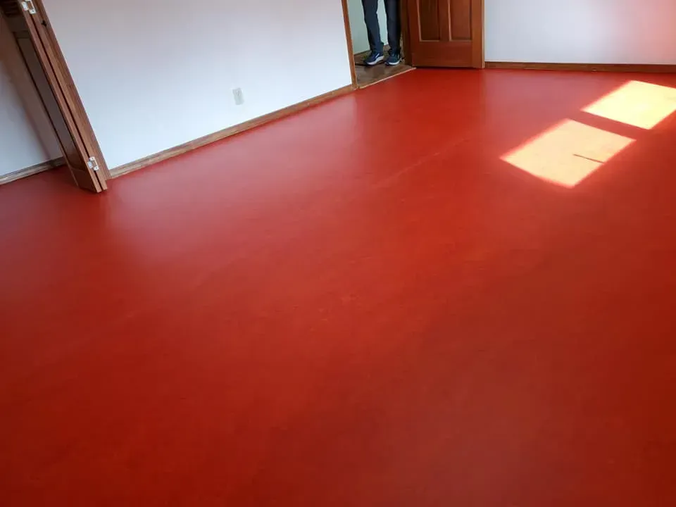 A room with a red floor and white walls