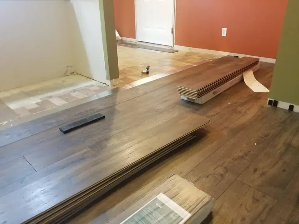 A wooden floor is being installed in a room.