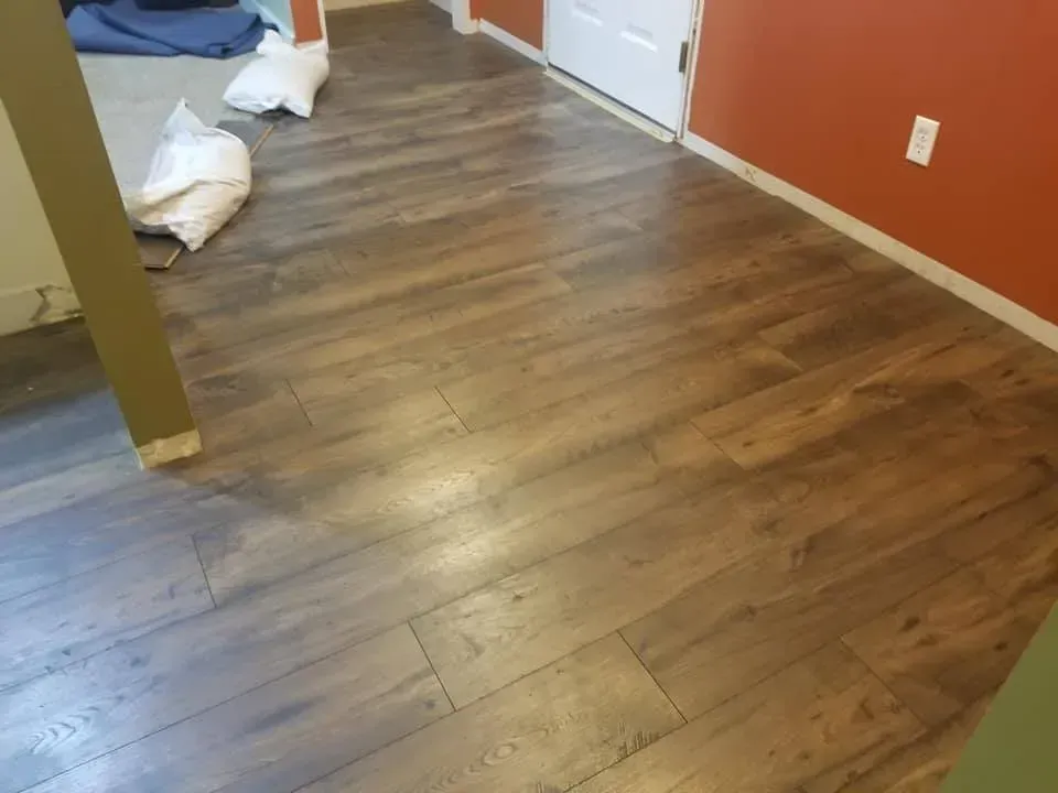 A room with a wooden floor and red walls.