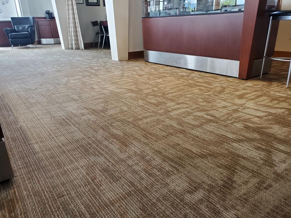 A large room with a carpeted floor and a wooden counter.