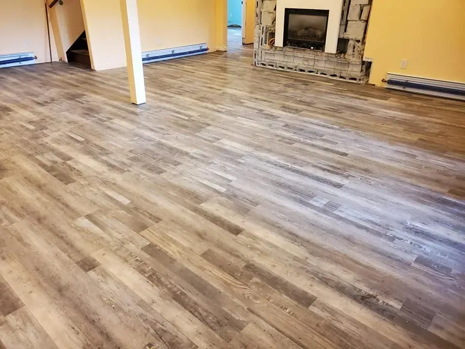 A living room with hardwood floors and a fireplace.
